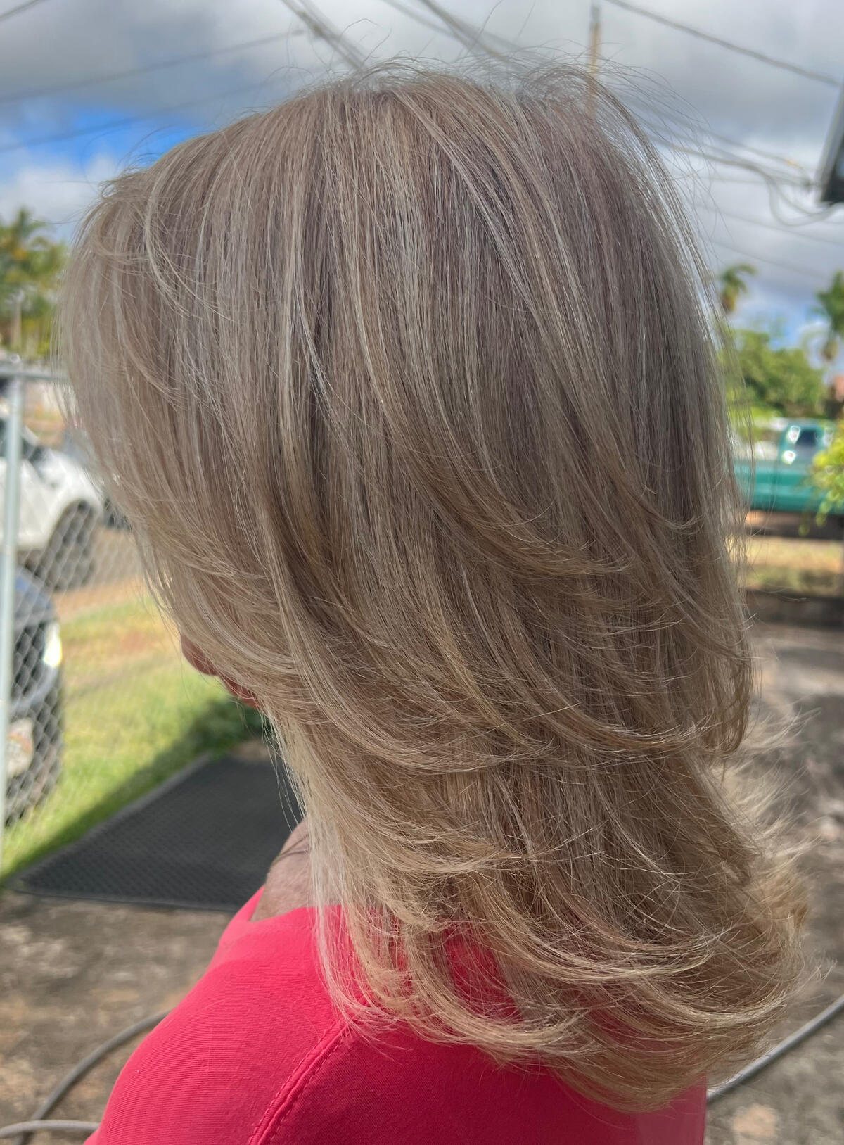 Layered blonde haircut with feathered ends at North Shore Haircuts